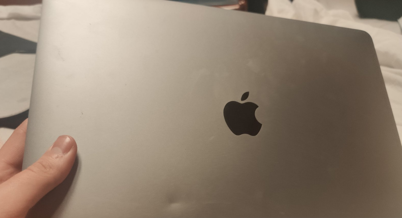 Laptop with dent on lid showing physical damage